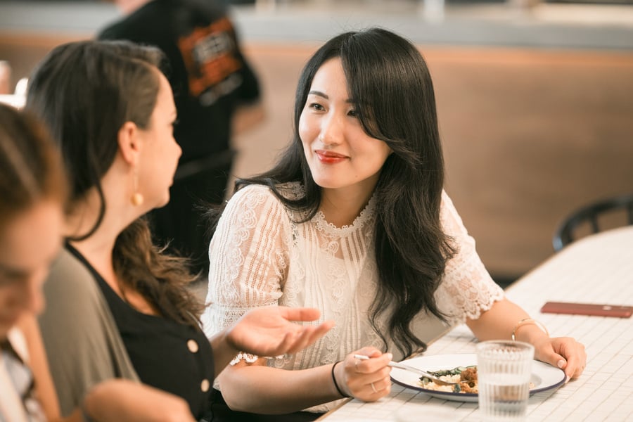 Women talking over lunch in the office
